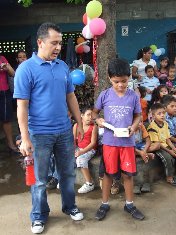 A boy welcoming us to the second Managua program reading to us from his Bible with Mario translating