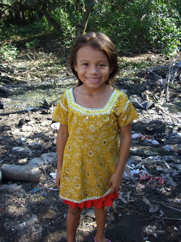 Milagro looking so pretty in her backyard - you can see the trash and barbed wire brought in with every heavy rain