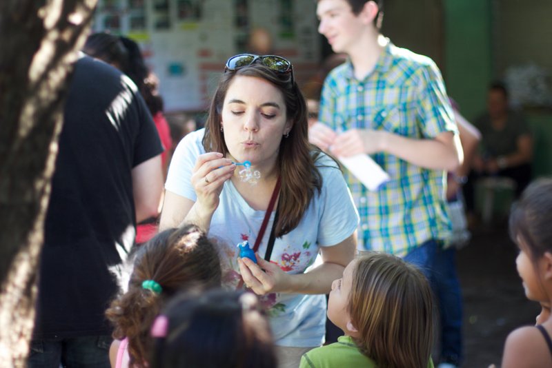 Blowing bubbles with the children at the school