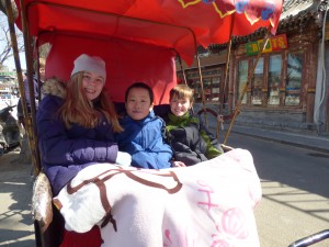 Rinnah, Noah, and Toby in the rickshaw