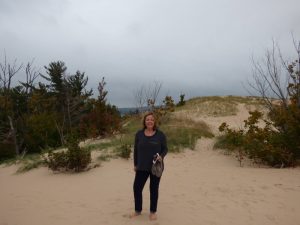 Chris on the dunes with Lake Michigan behind her